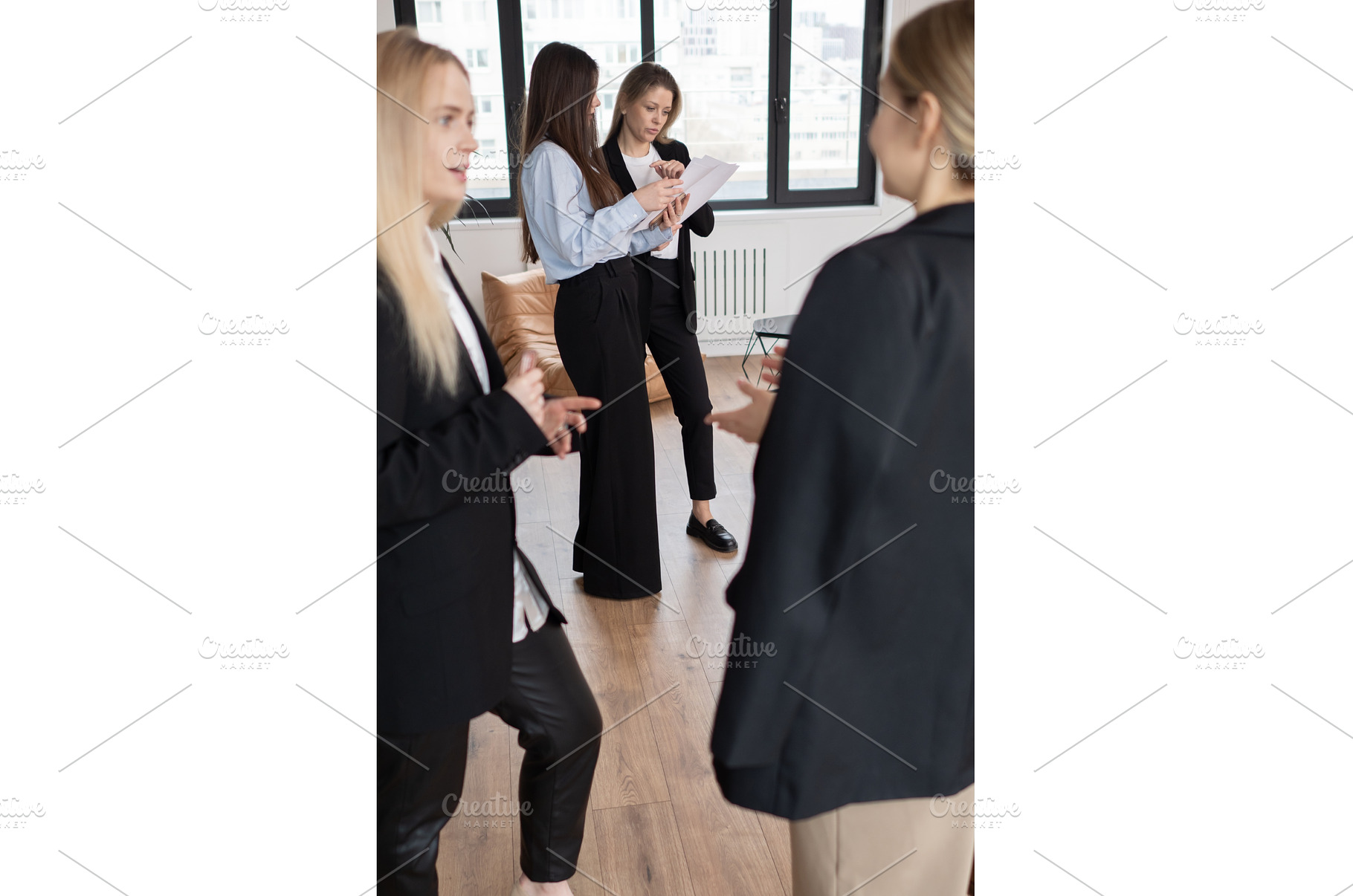 Four business women gathered in, a Business Photo by undrey