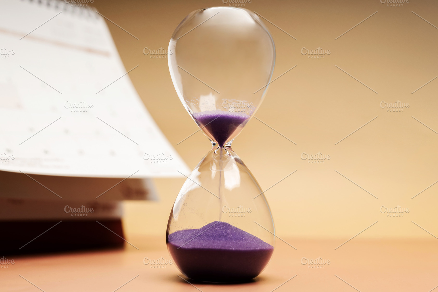 Hourglass beside calendar, time management, aging society and aw, a Photo by salmon.black