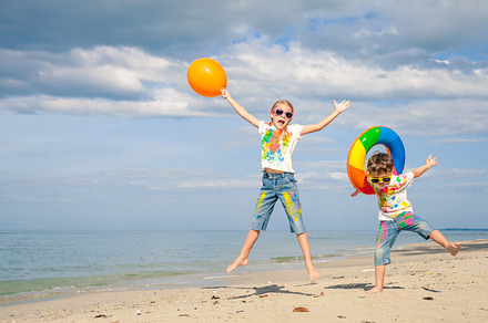 Happy children playing on the beach stock photo containing water and sister, a Person Photo by altanaka