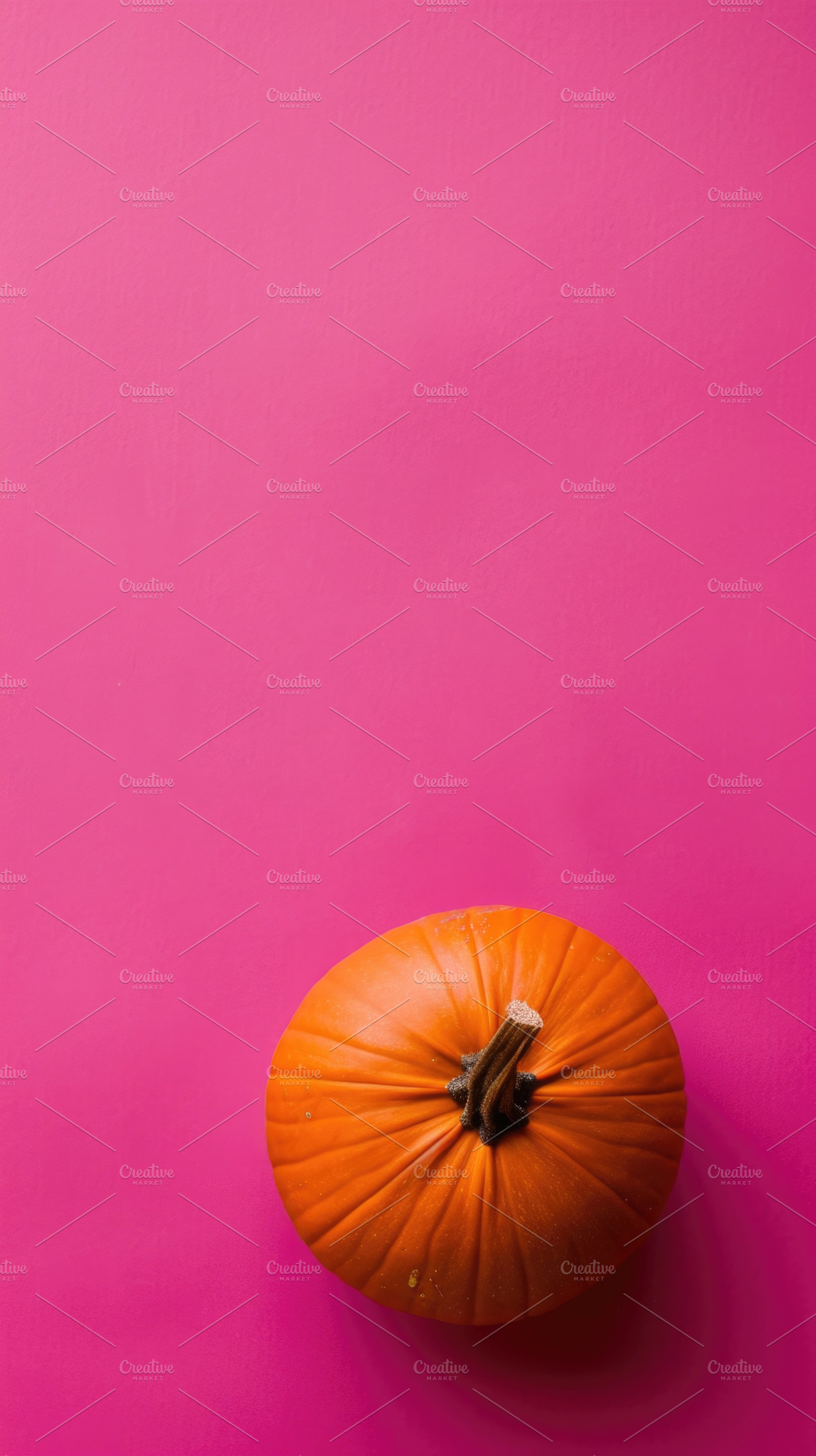 Top view orange pumpkin on pink Halloween background, a Food & Drink Photo by José Manuel Gelpi