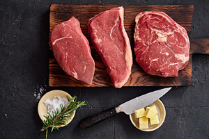 Rib-eye, roast beef, flank and rump steak on wooden cutting board with knife, s, a Food & Drink Photo by Asya Nurullina
