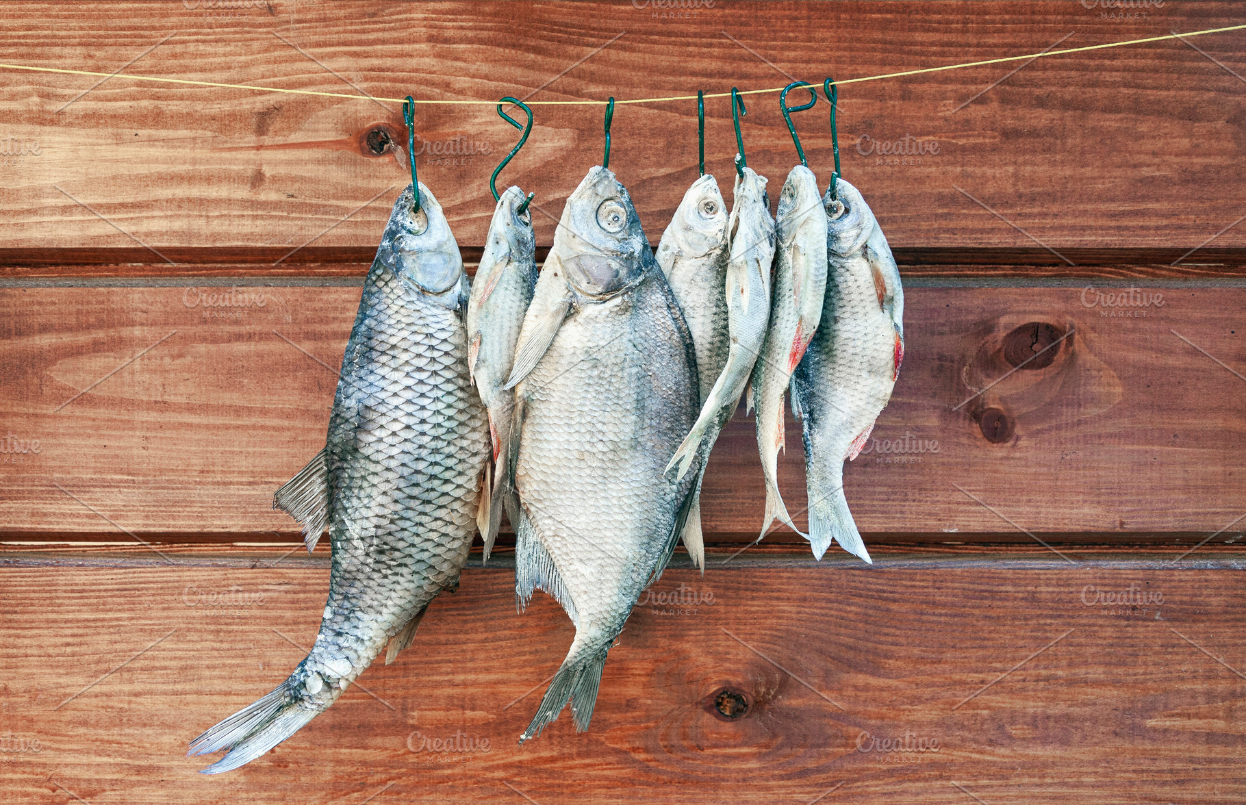 Dried salted fish hanging on a rope, a Food & Drink Photo by BOOCYS
