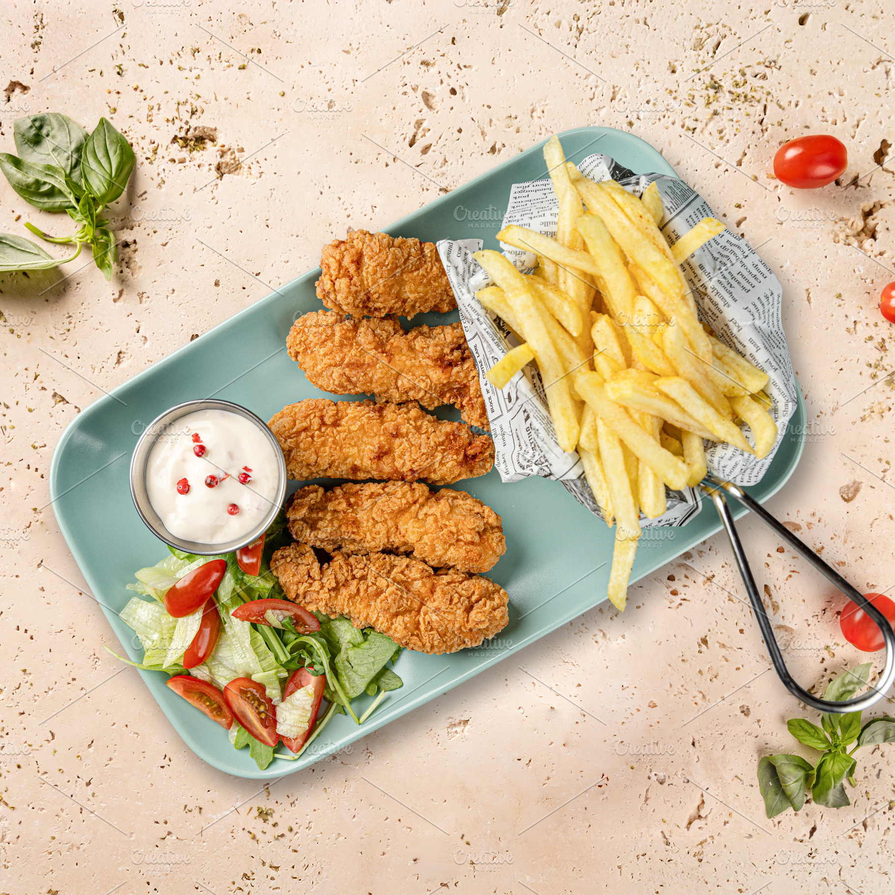 Breaded chicken strips served with french fries, a Photo by Grafvision photography