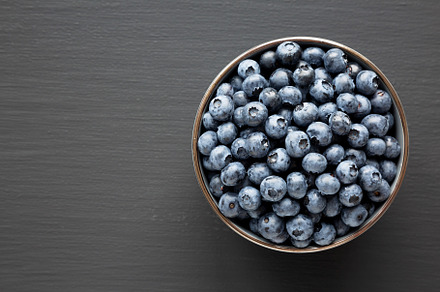 Organic Blueberries in a Bowl, top view. Flat lay, overhead, fro, a Food & Drink Photo by LiudmylaChuhunova