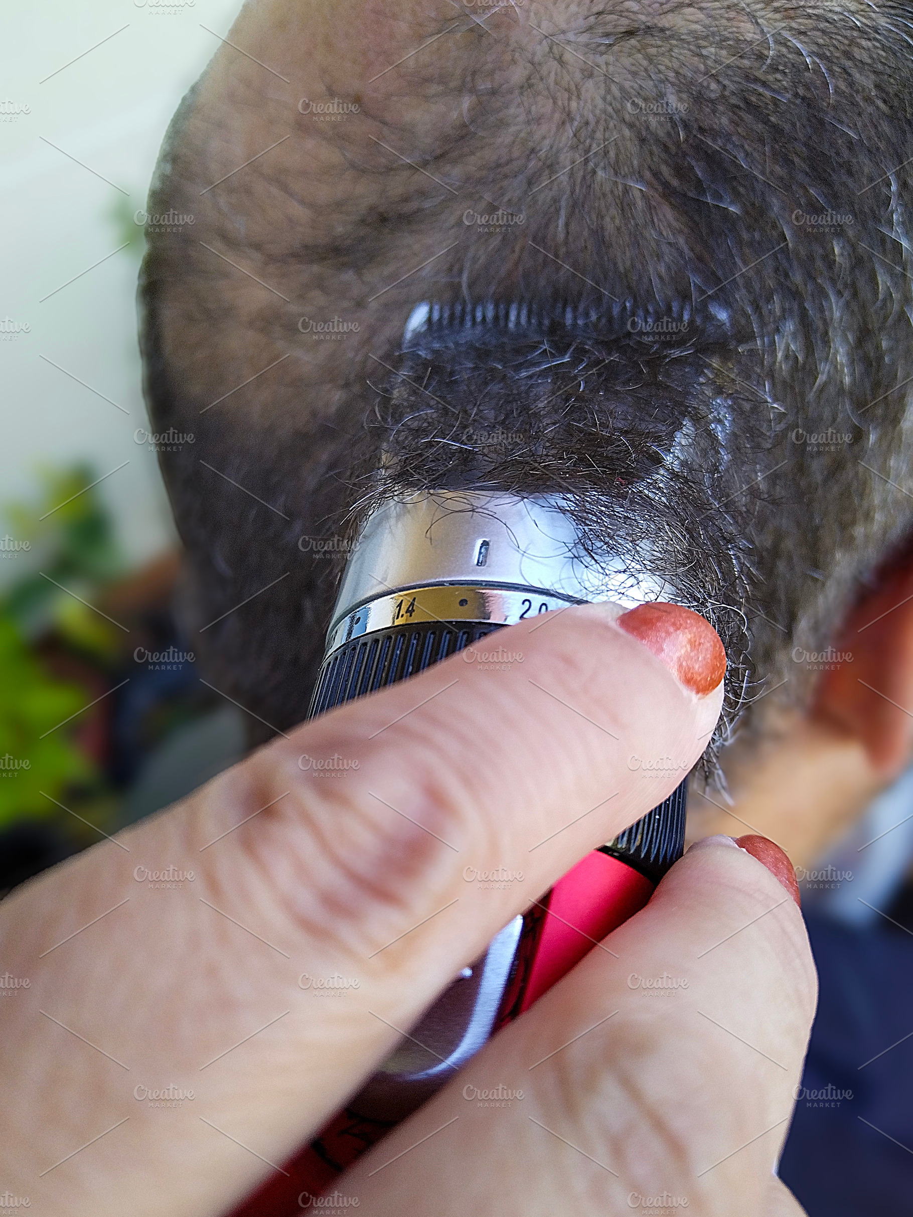 Man getting his head shaved with electric clippers, a Person Photo by DanFLCreativo