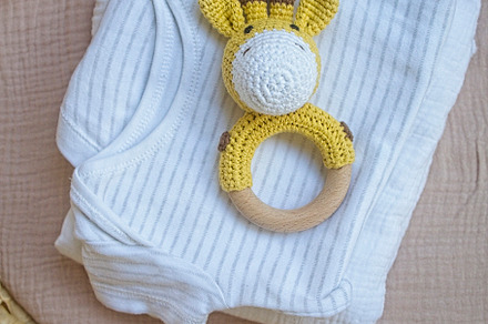 basket there are things for the baby and wooden and knitted toys