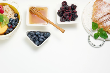 plate with oatmeal and fruit, half a ripe orange and freshly squ, a Food & Drink Photo by ndanko