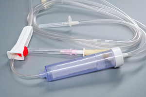 Close-up of Luer Slip TS-AD infusion set with metal spike and drip chamber. Det, a Health & Medical Photo by Rohan Photography
