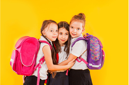 Cute girls in uniform with backpacks, a School & Education Photo by oksix