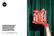 Christmas Gift on Gloved Hand Mockup, a Packaging Mockup by creatsy5 (Thumbnail 1 of 6)