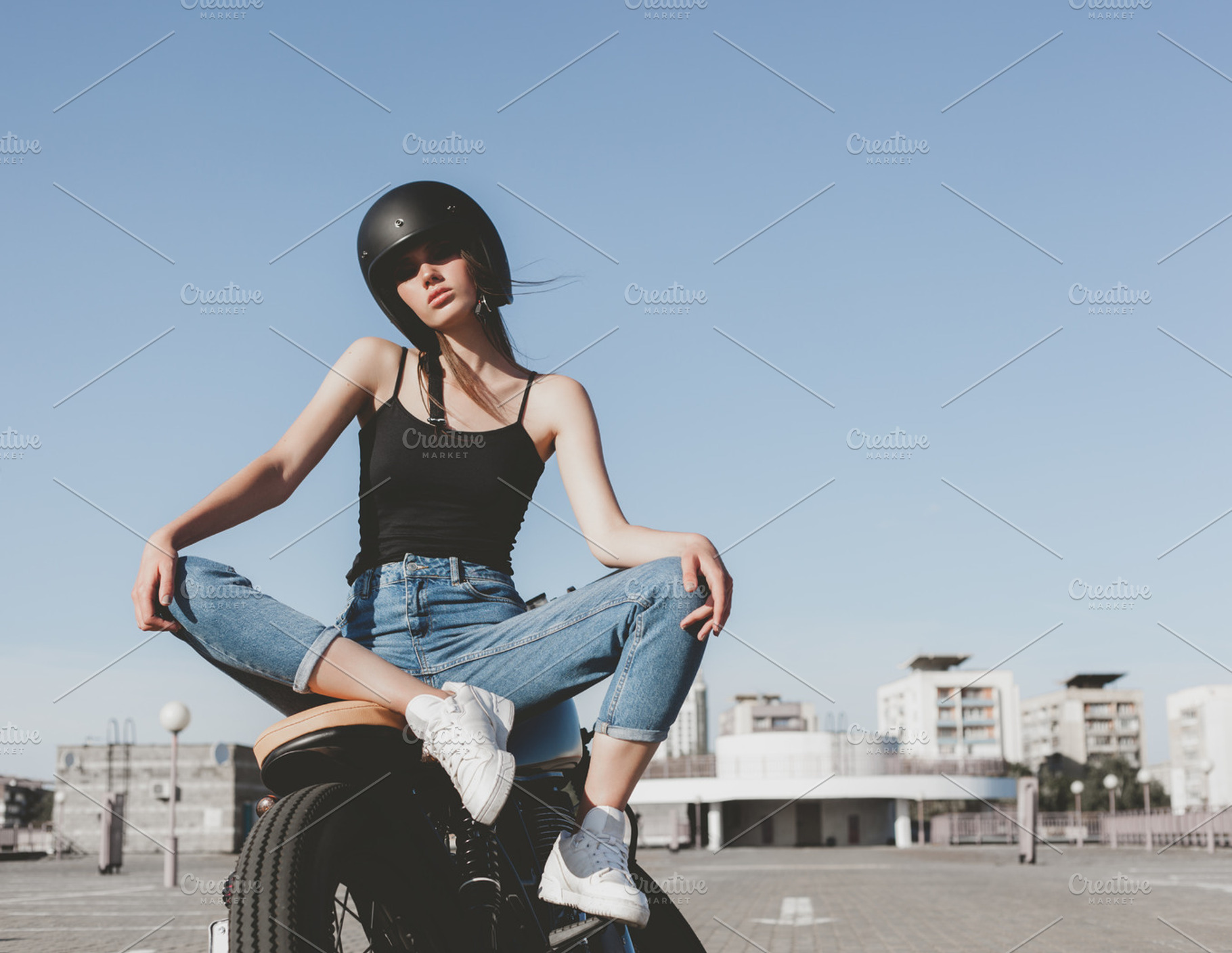 Girl sitting on motorcycle containing moto, caferacer, and bike, a Person Photo by Aliaksei Kaponia