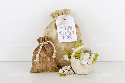 Bags with empty tag mockup, flowers, a Background Photo by Bubert Art
