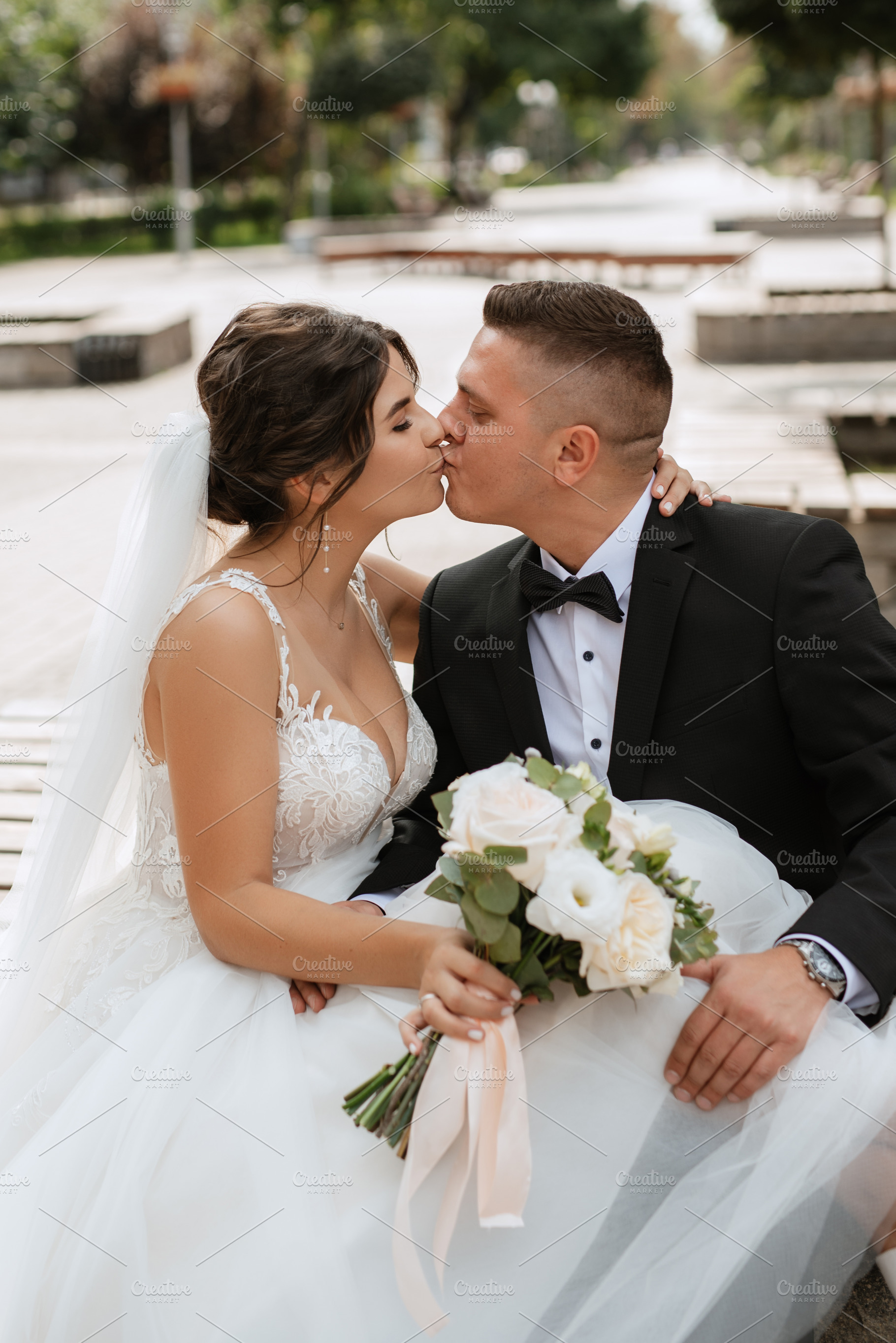 the groom in a brown suit and the bride in a white dress, a Person Photo by Weddings, People, Travel