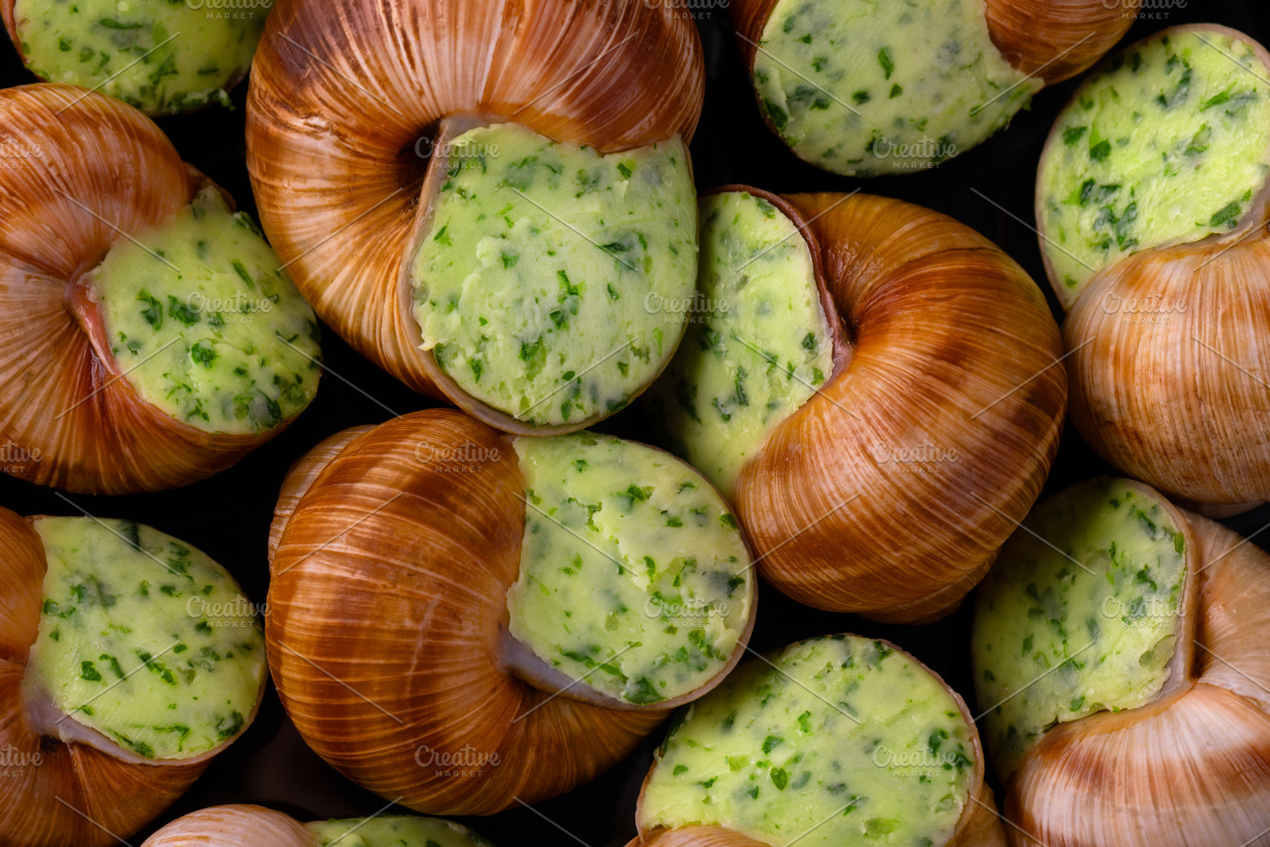 Close-up of traditional escargot shells filled with vibrant garl, a Food & Drink Photo by Ales Munt