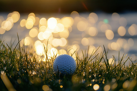 Atmospheric golf scene with sunset, a Photo by Pavel_design