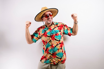Man celebrating with fists up in colorful shirt