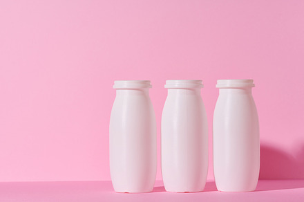 White plastic bottles for yogurt and dairy products on a pink ba, a Food & Drink Photo by ndanko