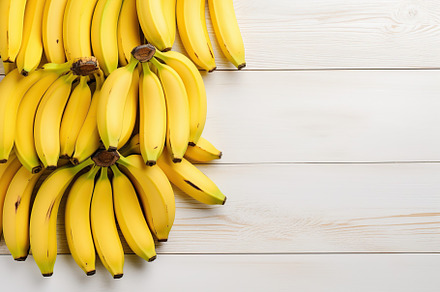 Ripe bananas on white wooden background, a Food & Drink Photo by AlyaAnd
