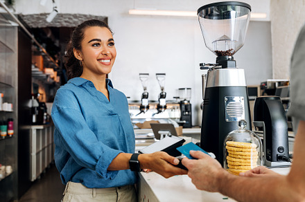 Smiling coffee shop owner, a Business Photo by Artem Varnitsin
