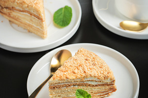 Medovik. Honey cake made from honey cakes with whipped sour cream, decorated wi, a Food & Drink Photo by Budarinphoto