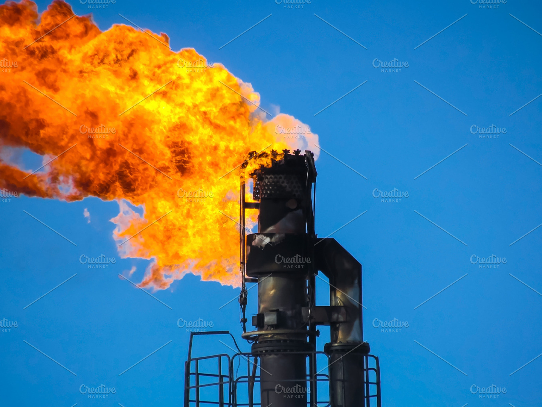 Torch system on an oil field stock photo containing gas and oil, an Industrial Photo by ELEONIMAGES