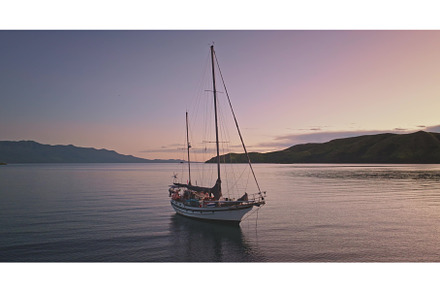 Sailboat floating on calm sea at
