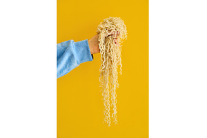 Hand holding clump of long cooked, a Food & Drink Photo by Gladkov photography