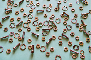 Scattered metal nuts bolts and