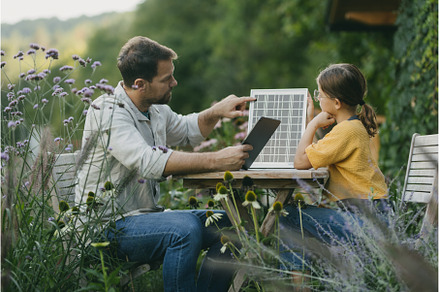 Father teaching daughter about solar, a School & Education Photo by HalfPoint