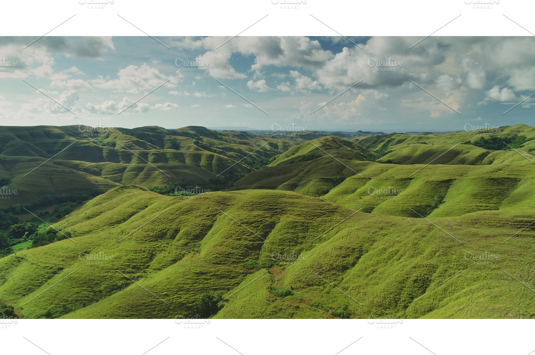 Aerial view of rolling green hills, a Nature Photo by Goinyk