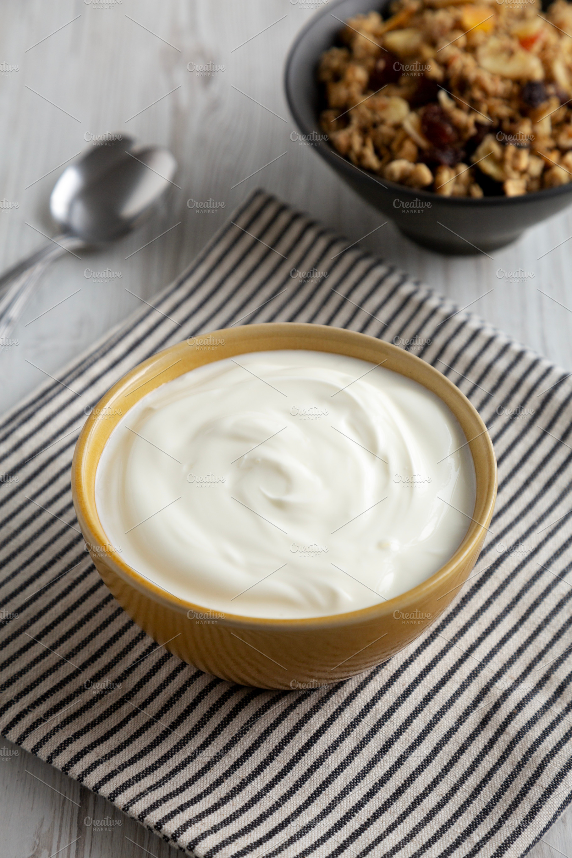 Organic Whole Fat Greek Yogurt in a Bowl, side view., a Food & Drink Photo by LiudmylaChuhunova