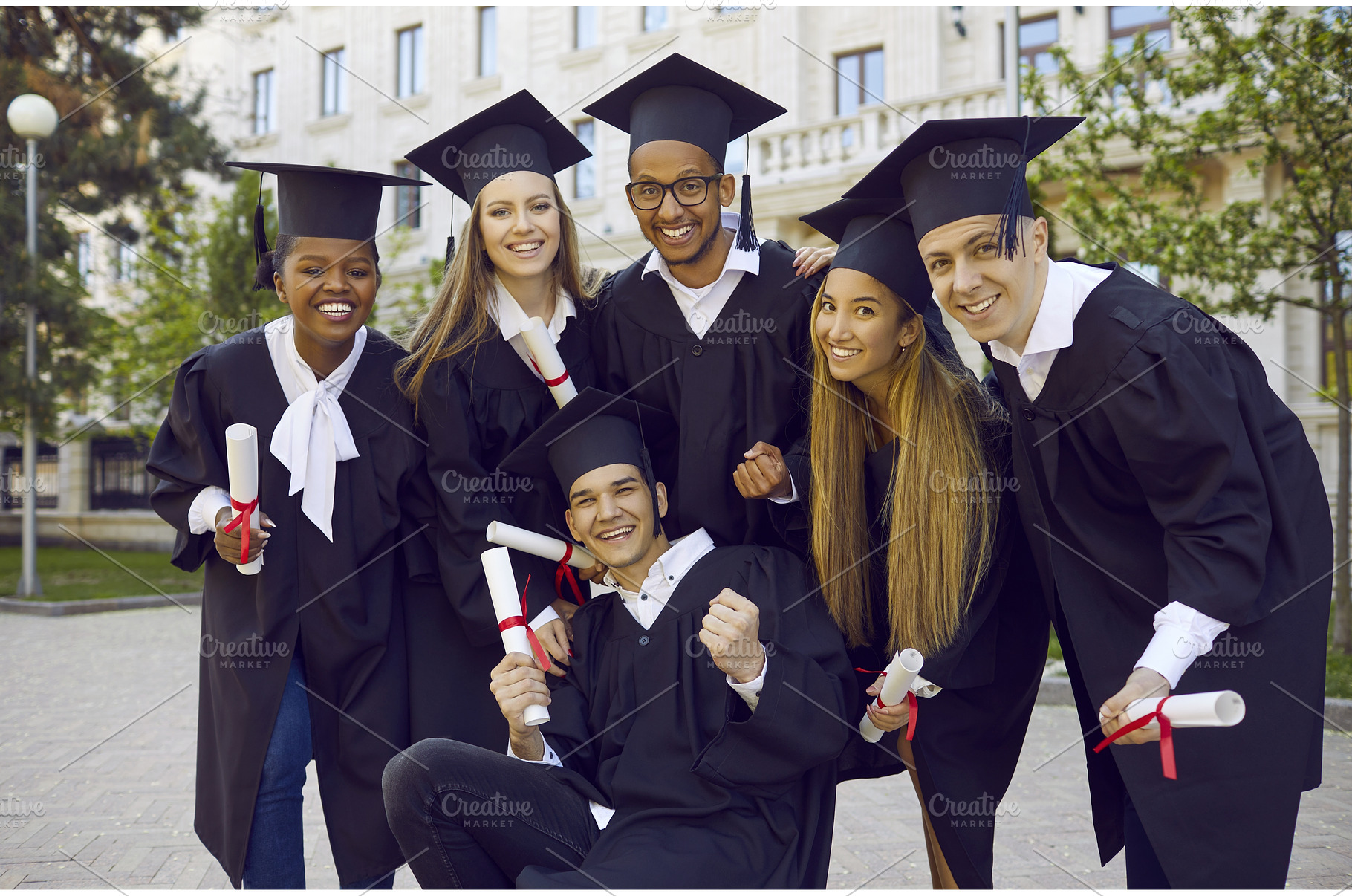 Happy university graduates in, a Person Photo by StudioRomantic