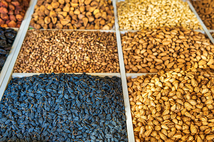 Oriental dried fruits and nuts on the counter of the bazaar., a Food & Drink Photo by Eugene_Photo