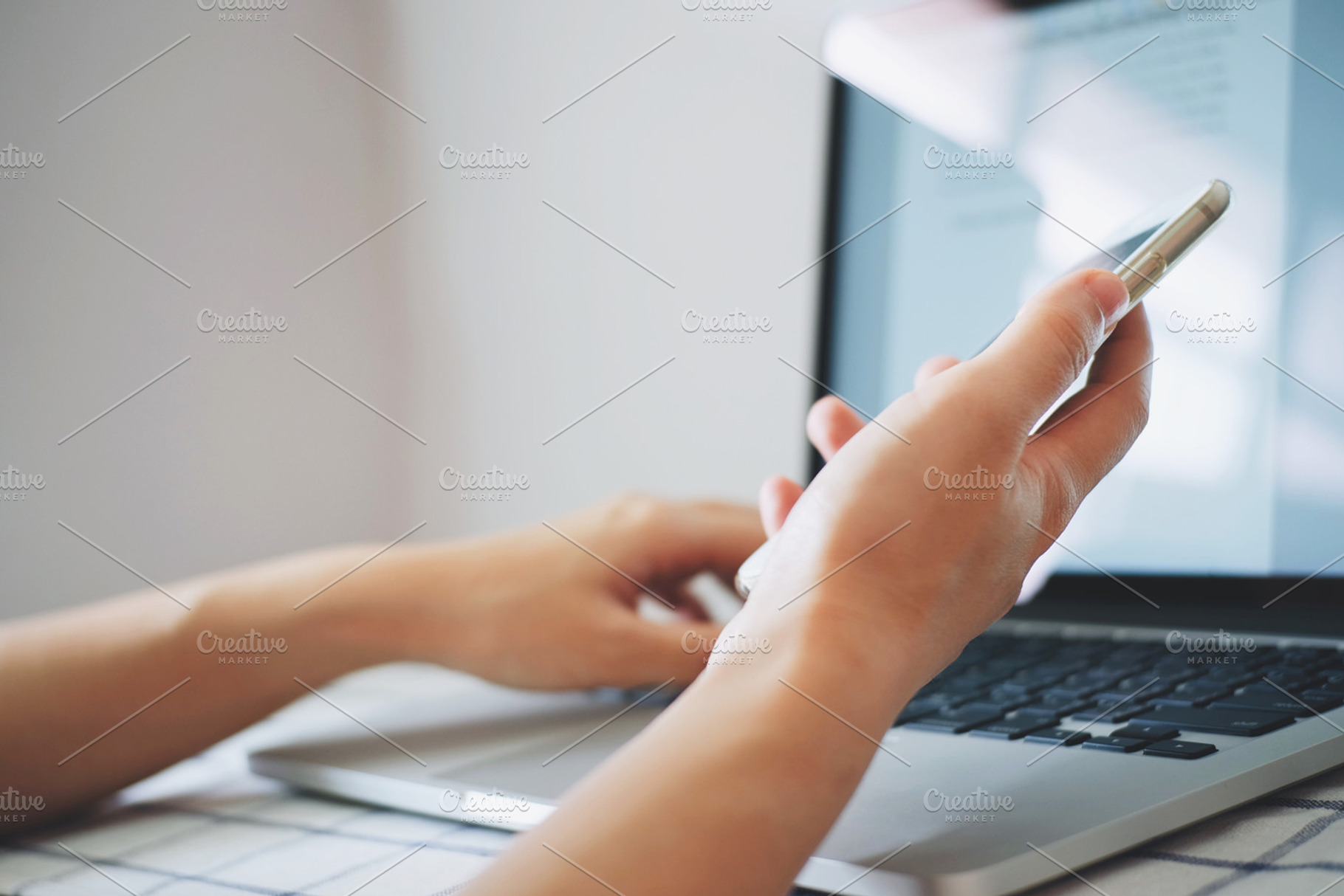 Hands using smartphone and laptop, a Technology Photo by PEMIKA
