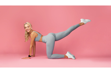 Smiling Young Woman Doing Exercise, a Person Photo by Prostock-Studio