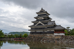 Historic Matsumoto Castle reflected in calm waters, Japan, a Nature Photo by GoodGoods