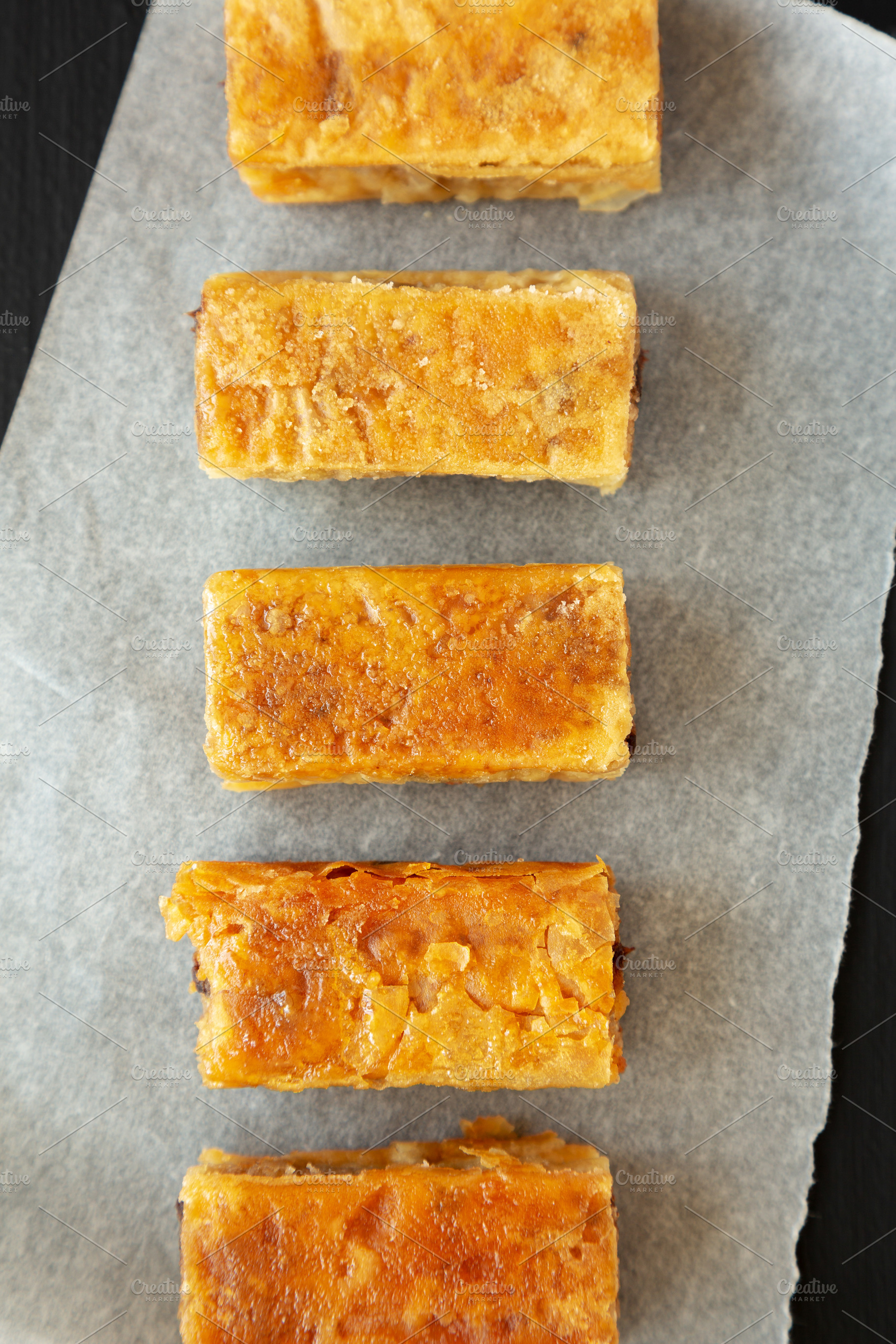 Homemade Baklavas with Honey, Chocolate and Almond on a black ba, a Food & Drink Photo by LiudmylaChuhunova