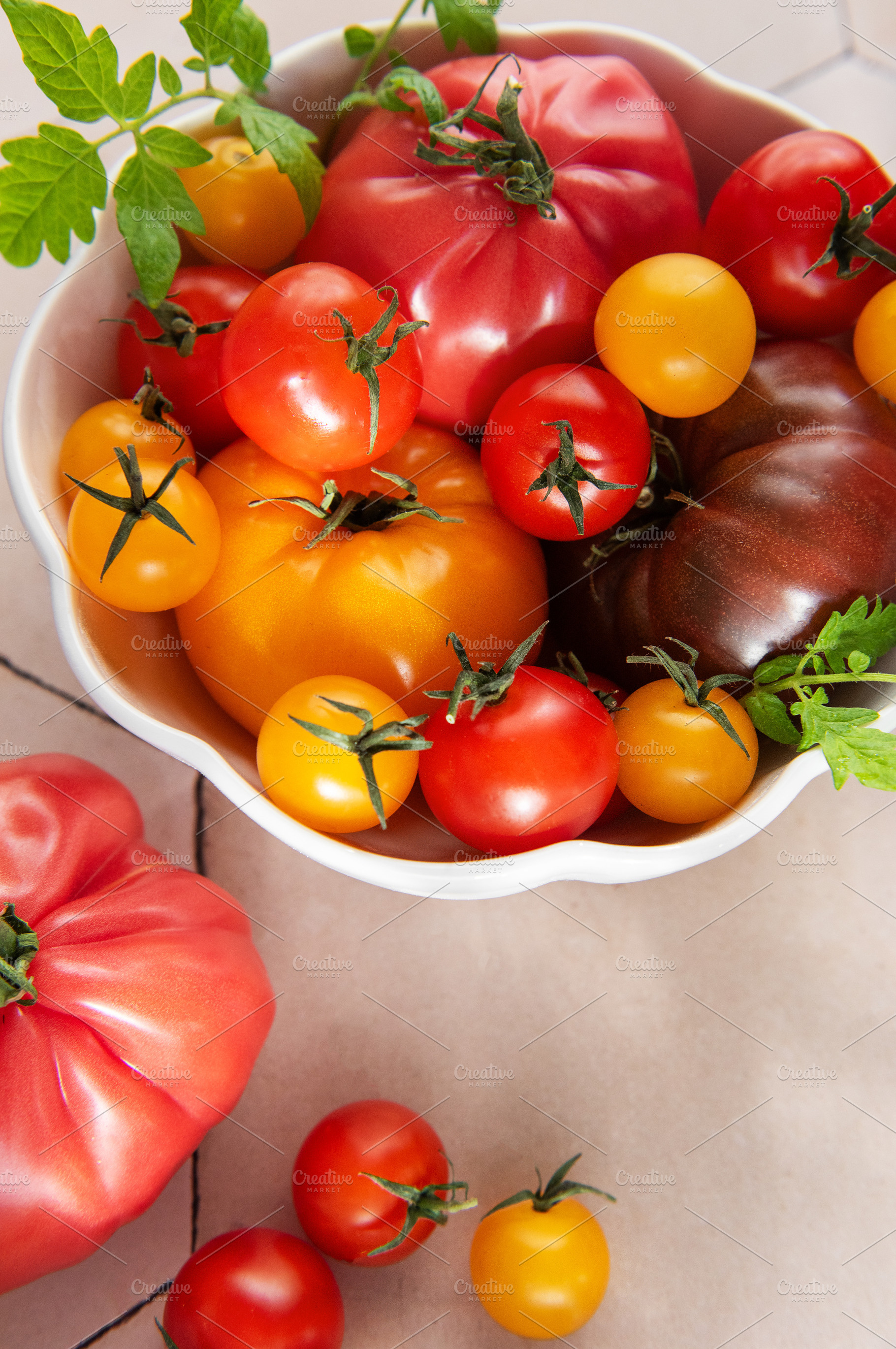Fresh organic heirloom tomatoes in white bowl, a Food & Drink Photo by Olena Rudo