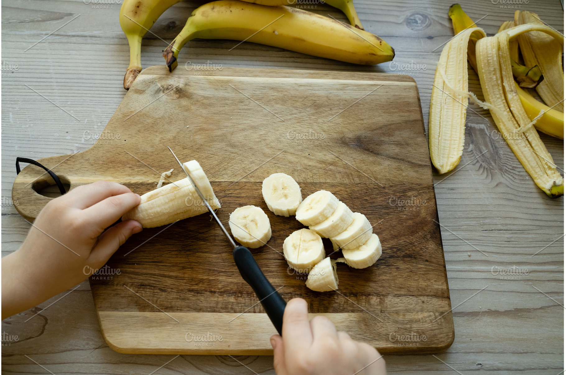 Cutted bananas on the wooden, a Food & Drink Photo by oksix