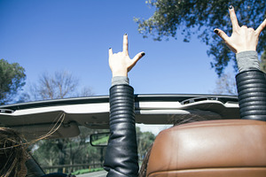 Hands of a woman in the air in a car featuring arms, automobile, and beauty