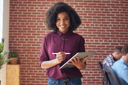 Successful african american business woman smiling using digital tablet computer female manager in office, a Photo by Peopleimages.com
