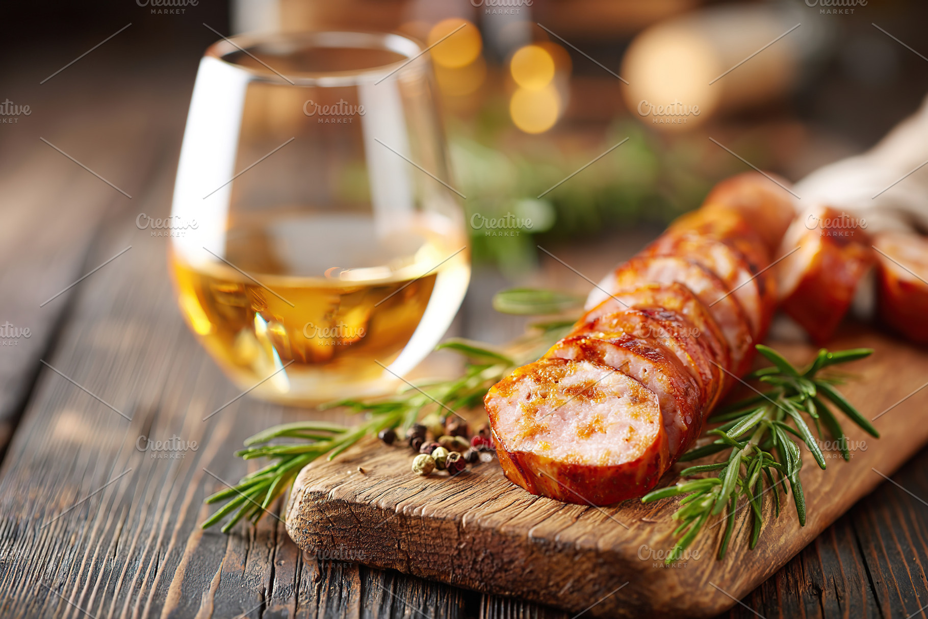 Smoked sausage on a wooden board with a glass of drink on a rustic table settin, a Photo by AlyaAnd