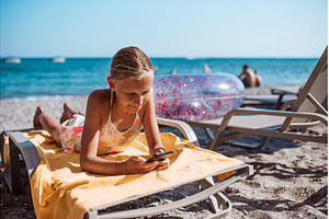 Gril relaxing on beach lounger with, a Nature Photo by HalfPoint