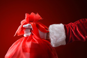 Santa's hand with a bag of gifts isolated background, a Person Photo by Davizro's Market