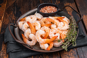 A plate of shrimp with a black bowl of salt and pepper. The shri, a Food & Drink Photo by composter-box@mail.ru