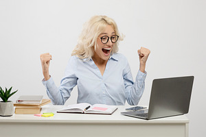 Overjoyed female entrepreneur using laptop and gesturing yes, celebrating busin, a Photo by Prostock-Studio