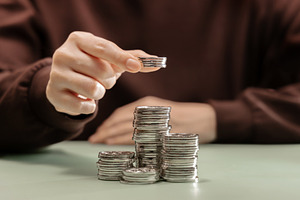 Growing stack of coins representing saving money, financial grow, a Photo by salmon.black