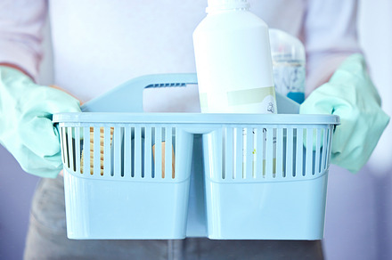 Woman, hands and cleaning tools in basket for housekeeping or detergent with latex gloves at home. Hand of female cleaner with bucket of clean chemicals for domestic work, dirt removal and hygiene, a Photo by Peopleimages.com