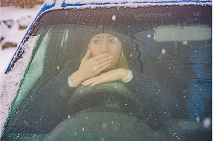 Woman in a car during a snowfall, a Transportation Photo by Elizaveta Galitskaya