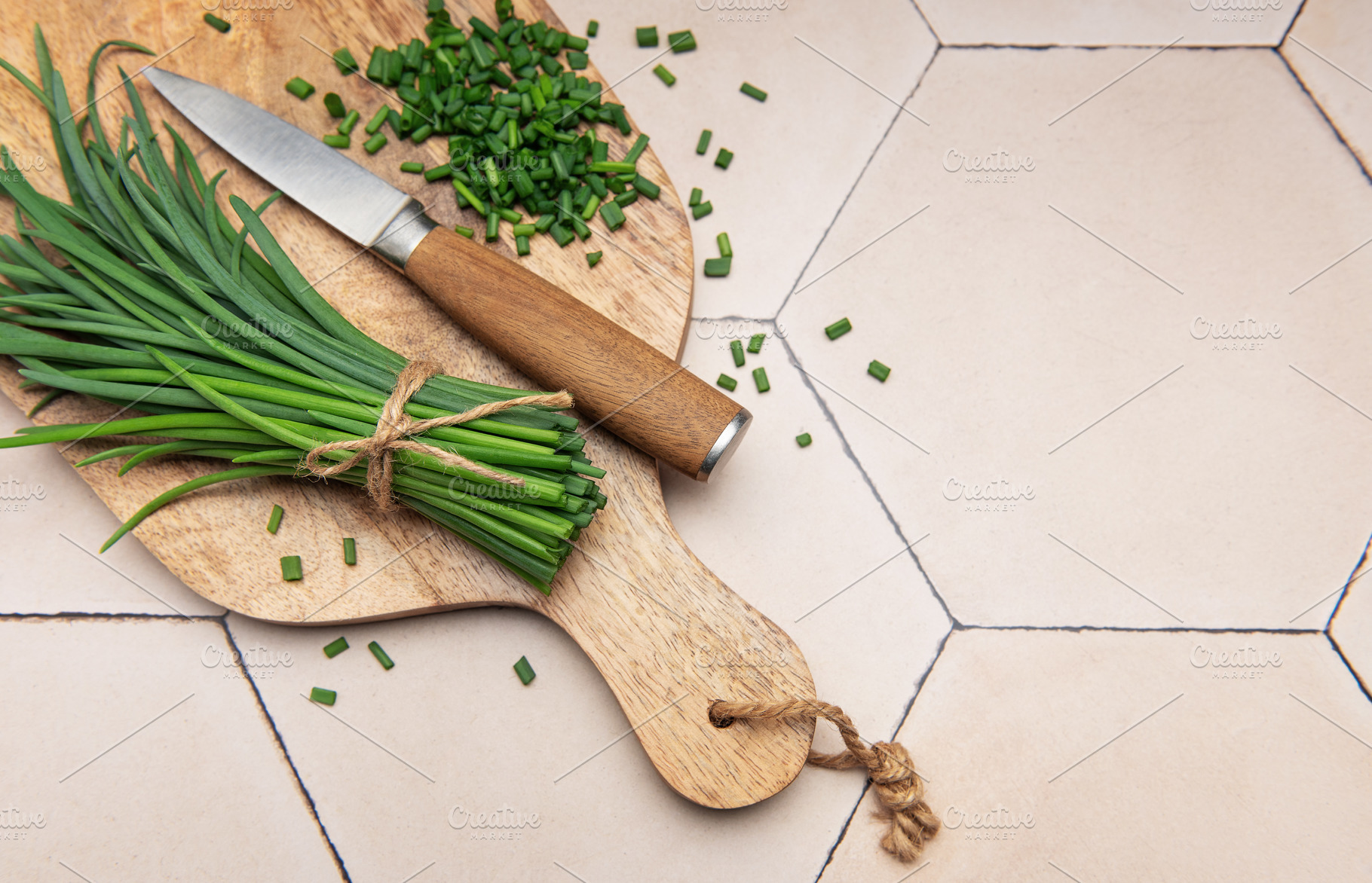 Fresh chopped chives on wooden cutting board, a Food & Drink Photo by Olena Rudo
